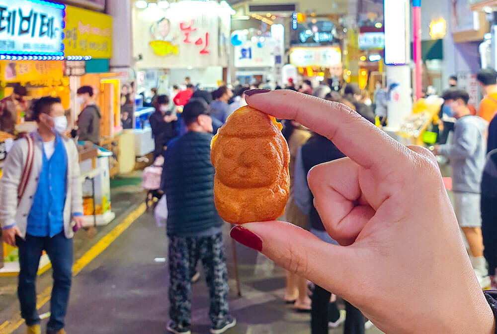 streetfood snack from a stall at seogwipo maeil olle market on jeju island