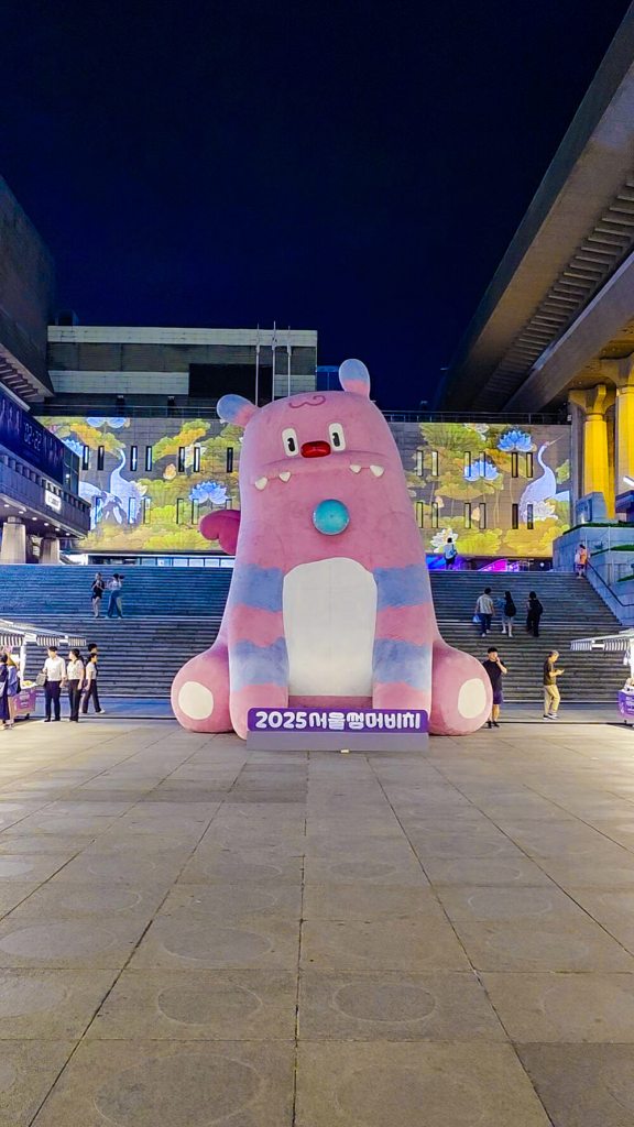 a large haechi statue in front of an illuminated building
